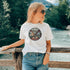 The In My Element t-shirt features a striking circular graphic representing the four classical elements—Fire, Water, Wind, and Earth.